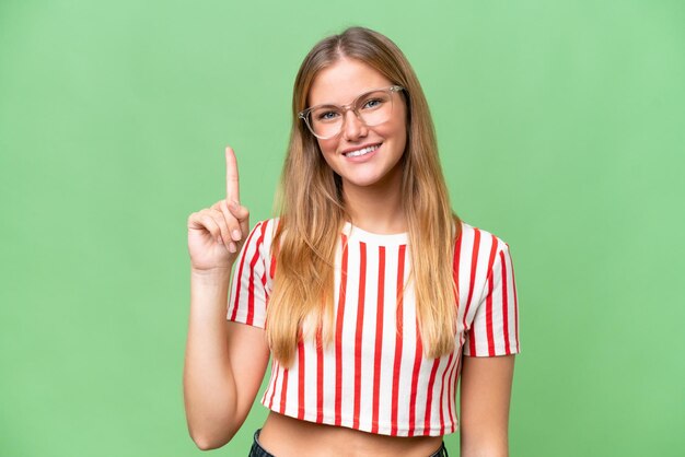 Young beautiful woman over isolated background showing and lifting a finger in sign of the best