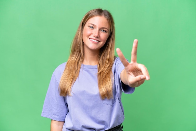 Young beautiful woman over isolated background smiling and showing victory sign