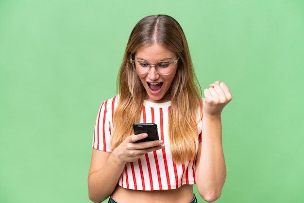 Young beautiful woman over isolated background surprised and sending a message