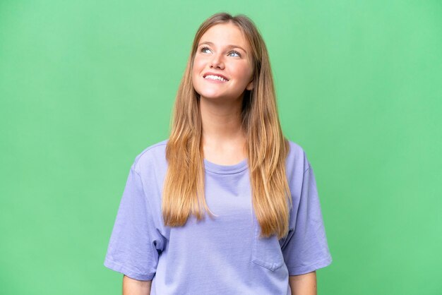 Young beautiful woman over isolated background thinking an idea while looking up