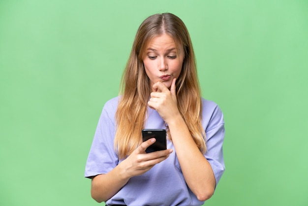 Young beautiful woman over isolated background thinking and sending a message