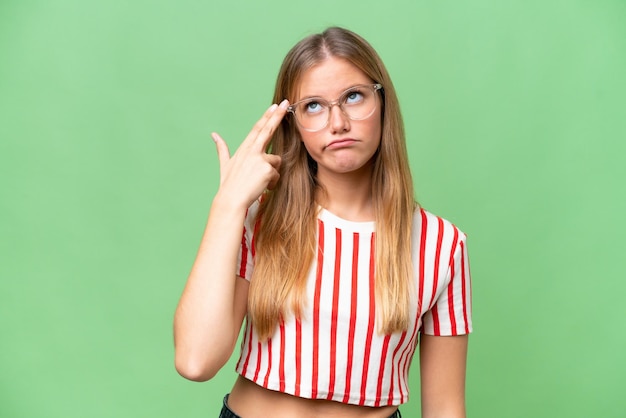 Photo young beautiful woman over isolated background with problems making suicide gesture