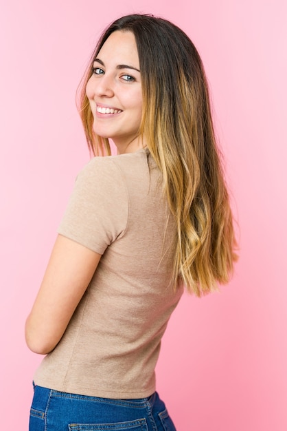 Young beautiful woman isolated on pink wall