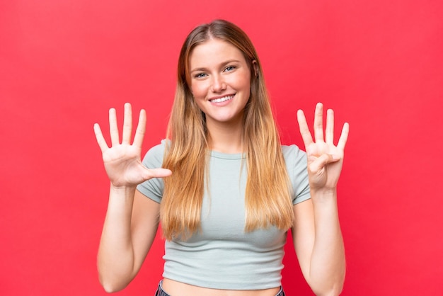 Young beautiful woman isolated on red background counting nine with fingers