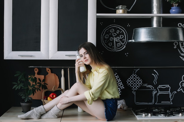 young beautiful woman in the kitchen at home