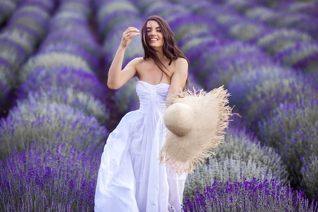 Young beautiful woman in lavender field. Lady on summer background