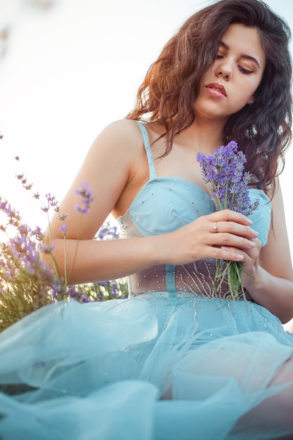 Young beautiful woman in a lavender field