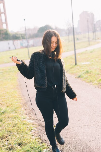 young beautiful woman listening to music with headphones