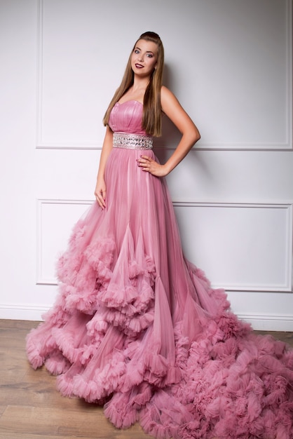 young beautiful woman in long pink dress