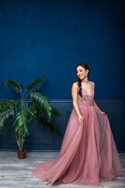 Young beautiful woman in long stylish evening dress