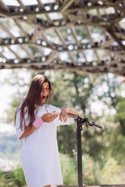 Young beautiful woman looks surprised in the park