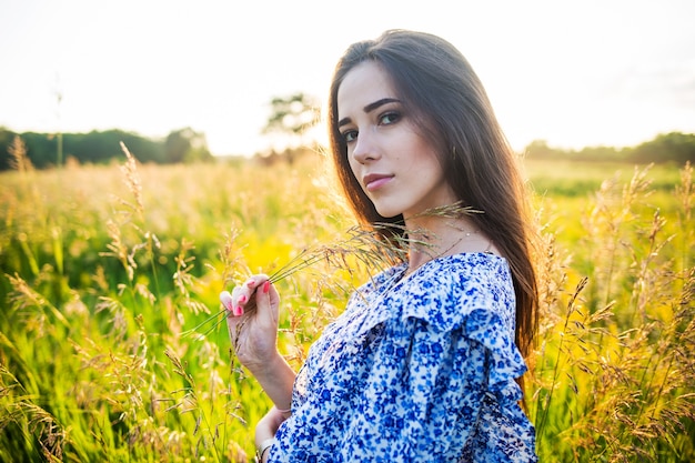 Young beautiful woman in the middle of a field