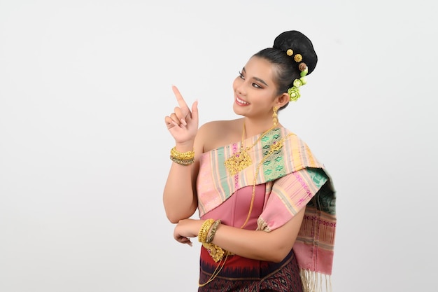 Young beautiful woman in northeastern dress stand and point finger posture