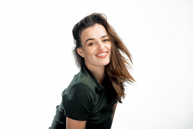 Young beautiful woman portrait with long brown hair over white studio background Positive emotions concept Closeup