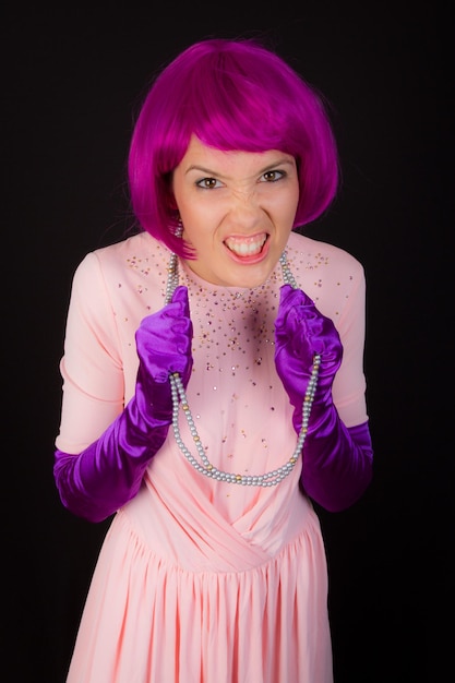 Young and beautiful woman in purple wig and dress