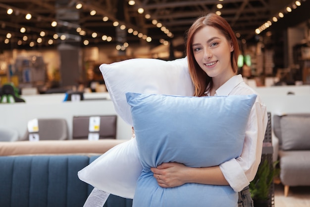 Young beautiful woman relaxing in a furniture store