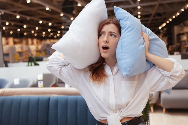 Young beautiful woman relaxing in a furniture store