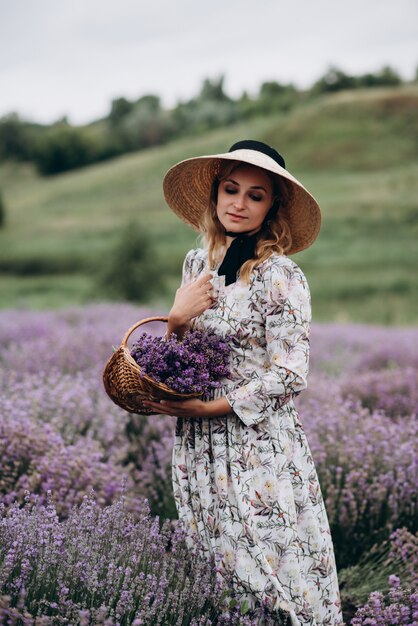 Young beautiful woman in a romantic dress in the lavender field