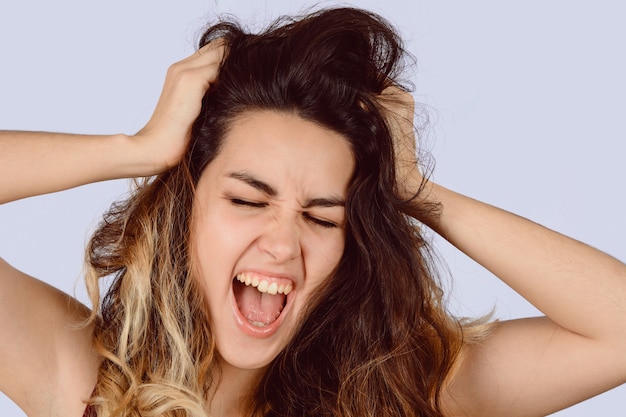 Young beautiful woman screaming.