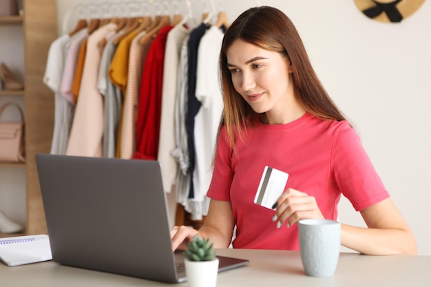 Young beautiful woman shopping online at home