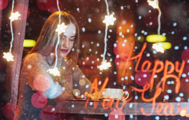 Young beautiful woman sitting in cafe, drinking coffee. 