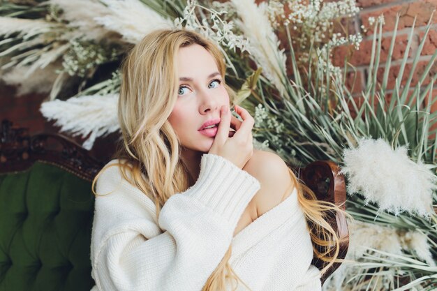 young beautiful woman sitting in a vintage sofa