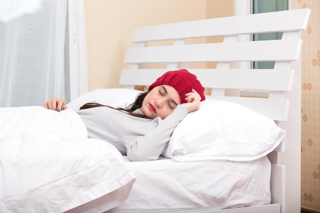 Young beautiful woman sleeping in her bed and relaxing in the morning