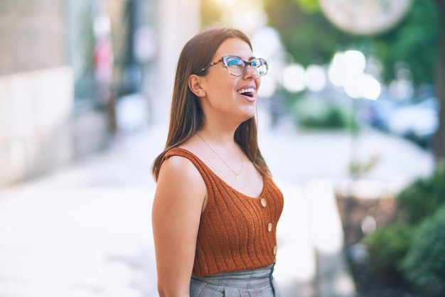 Young beautiful woman smiling happy and confident Standing with smile on face at the town street