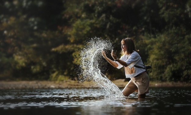 Young beautiful woman splashing water on summer vacation holiday relaxing