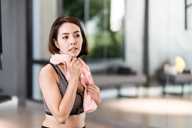 Young beautiful woman in sportswear working out in gym