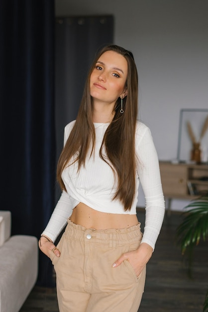 Young beautiful woman standing at home