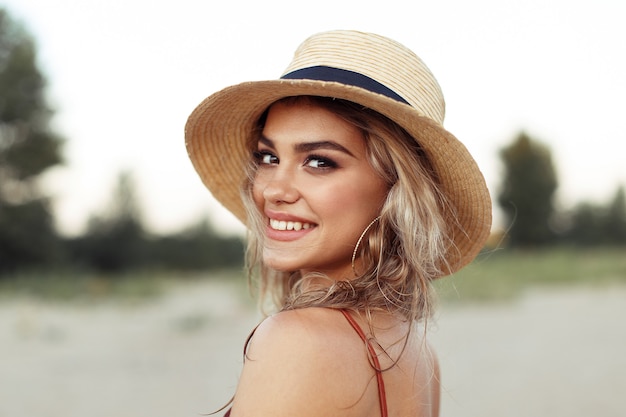 Young beautiful woman in a straw hat on vacation.