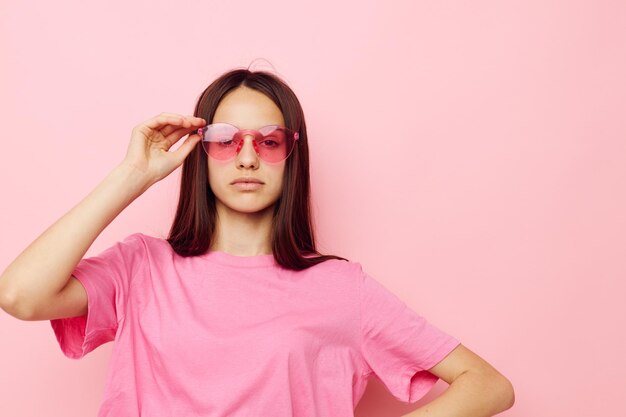 Young beautiful woman in stylish glasses posing emotions isolated background