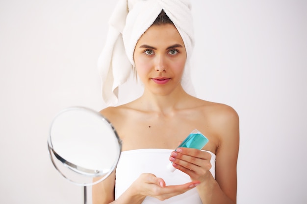 Young and beautiful woman taking care of herself after a bath