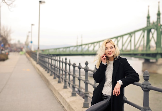 young beautiful woman talking on the phone on the street