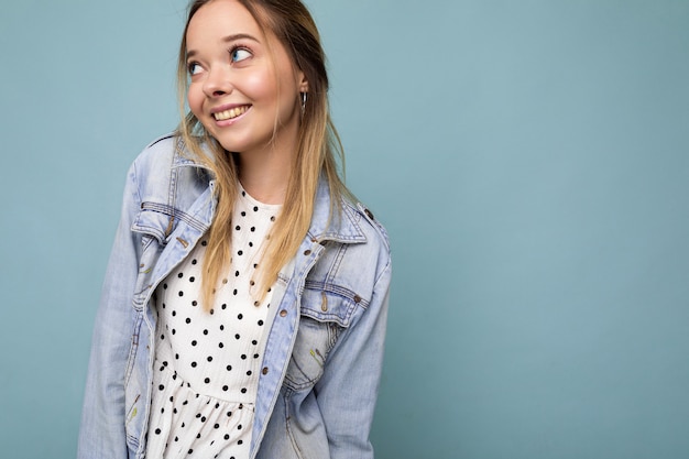 Young beautiful woman trendy woman in casual summer dress and stylish denim jacket positive female