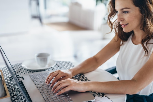 Young beautiful woman using a laptop computer at home