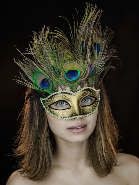 Young beautiful woman in a Venetian masquerade mask