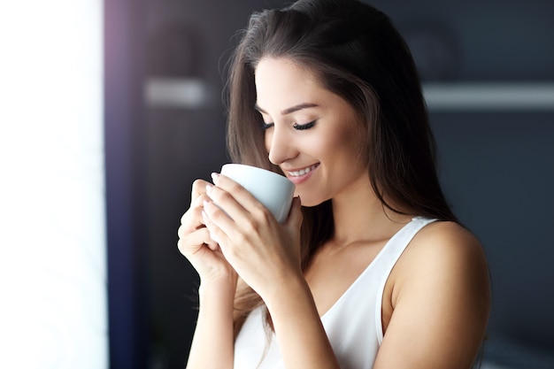 young beautiful woman waking up in her bed fully rested