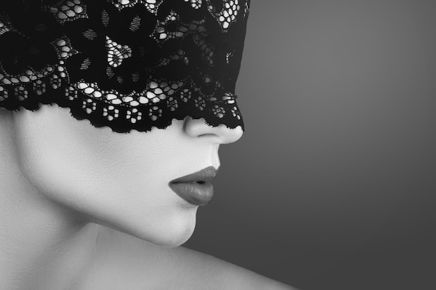 Young beautiful woman wearing black lace blindfold