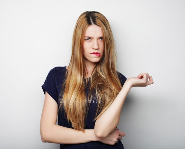 Young beautiful woman wearing casual clothes, posing on white background