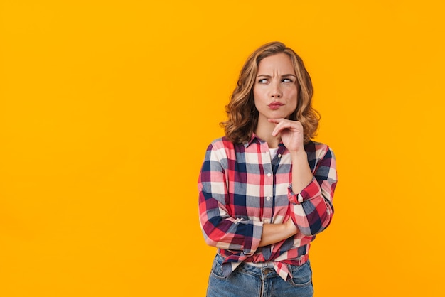 young beautiful woman wearing plaid shirt expressing concern isolated