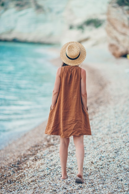 Young beautiful woman on white tropical beach.