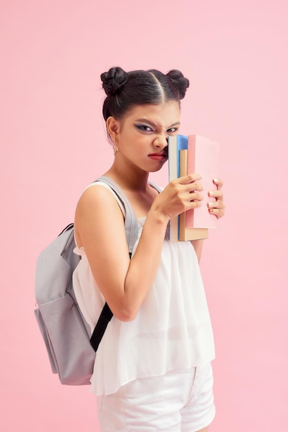 Young beautiful woman with books and a backpack Student going to school Education concept