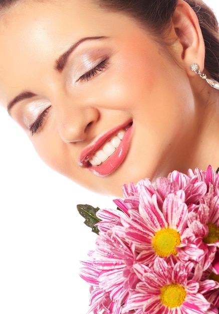 Young beautiful woman with bouquet of pink flowers isolated on