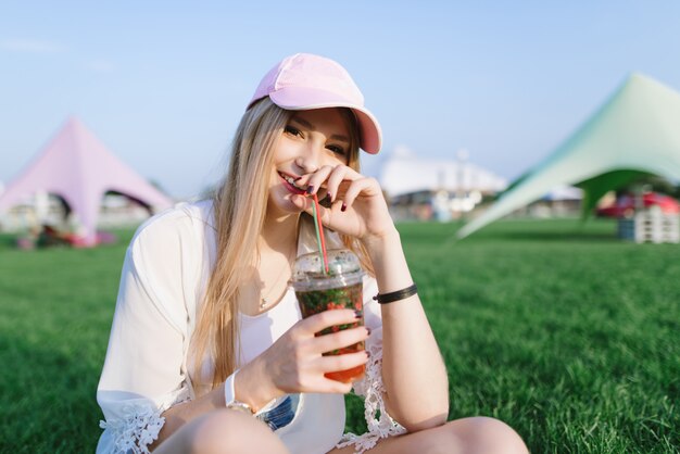 Young beautiful woman with a cap at a summer festival