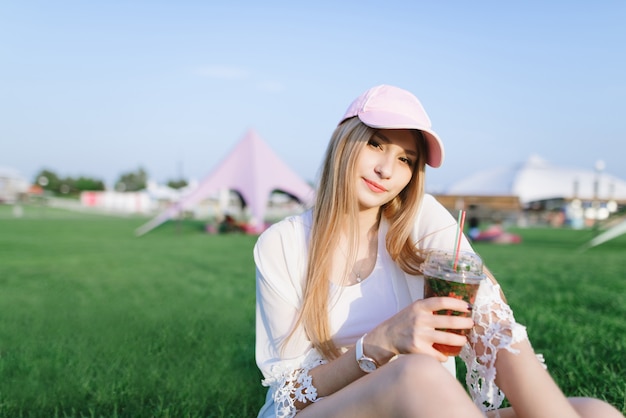 Young beautiful woman with a cap at a summer festival