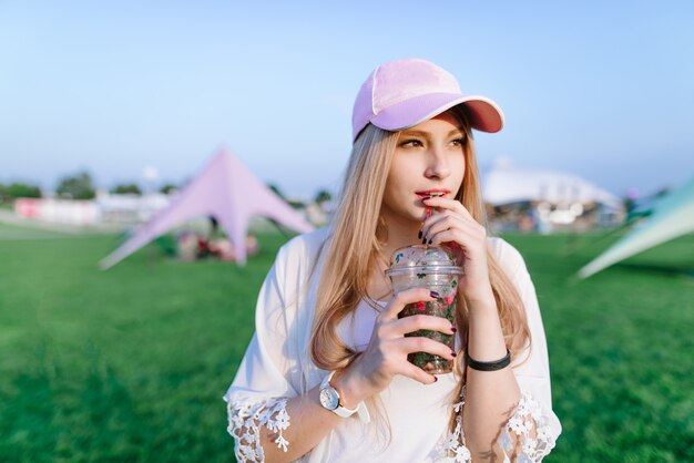 Young beautiful woman with a cap at a summer festival