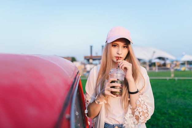 Young beautiful woman with a cap at a summer festival