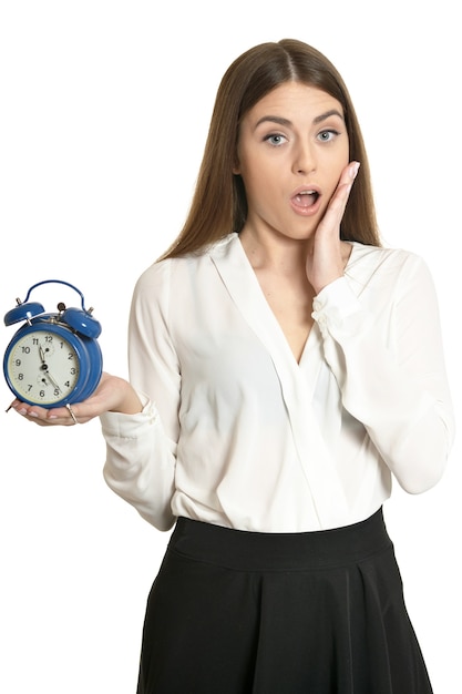 Young beautiful woman with the clock against white background